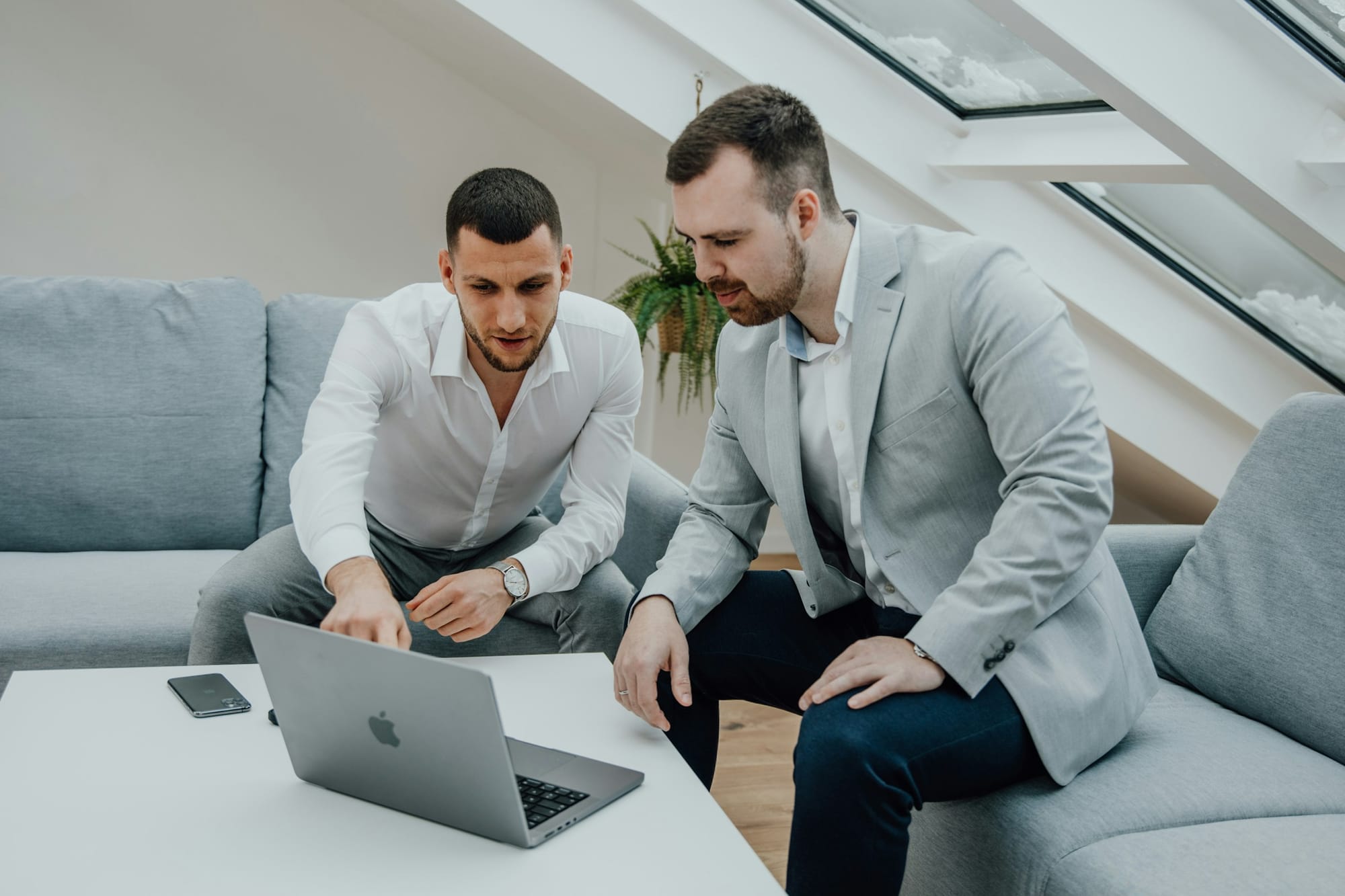 men working on a laptop - Gen AI vs AI
