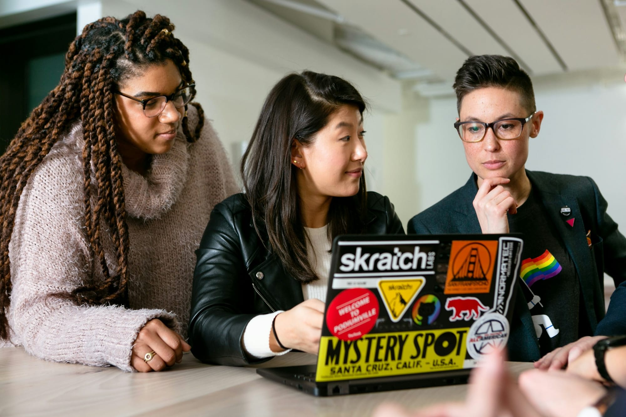 team looking at laptop - How to Use LLM 