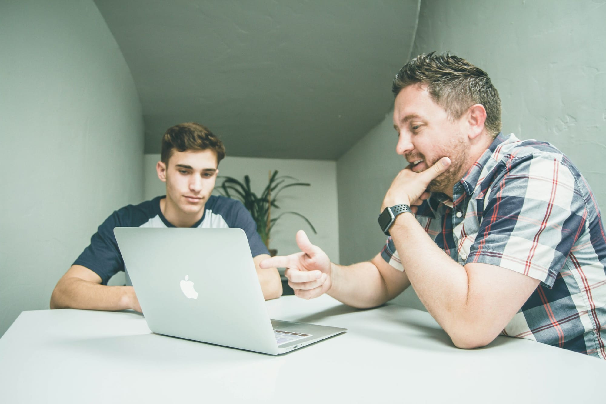 Person Pointing at Laptop - Mobile App Development Frameworks