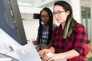 women on a computer - AI Integration Strategies